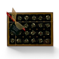 Chocolat in Kirkby Lonsdale gift box of 24 dark chocolate rum truffle Christmas puddings with holly decorations.