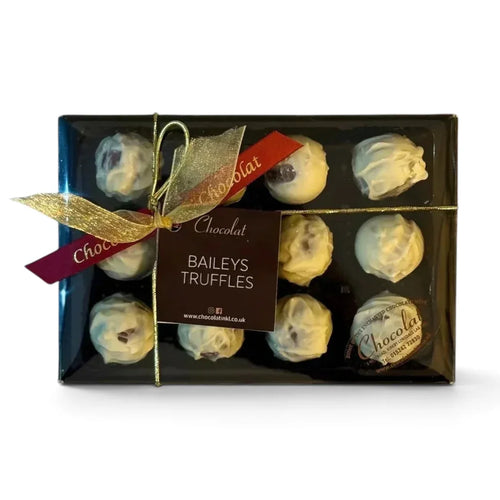 Chocolat in Kirkby Lonsdale gift box of 12 white chocolate Baileys truffles with a decorative red and gold ribbon.