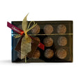 Chocolat in Kirkby Lonsdale gift box of 12 milk chocolate crème brûlée truffles with a sugar finish and gold ribbon