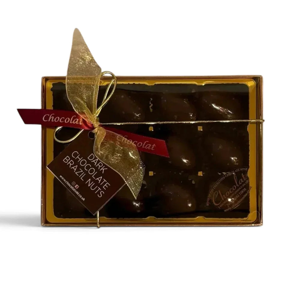 Chocolat in Kirkby Lonsdale gift box of 12 dark chocolate covered Brazil nuts with a gold ribbon and branded tag.