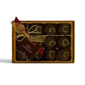 Chocolat in Kirkby Lonsdale gift box of 12 dark chocolate mint fondants with green swirl decoration and gold ribbon.