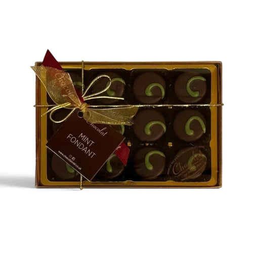 Chocolat in Kirkby Lonsdale gift box of 12 dark chocolate mint fondants with green swirl decoration and gold ribbon.