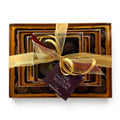 Chocolat in Kirkby Lonsdale luxury stack of 46 dark chocolates wrapped with a gold ribbon and branded gift tag