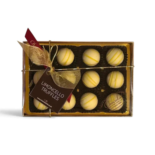 Chocolat in Kirkby Lonsdale gift box of 12 white chocolate Limoncello truffles with yellow drizzle and gold ribbon.