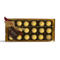 Chocolat in Kirkby Lonsdale gift box of 18 white chocolate truffles with yellow drizzle, tied with a gold ribbon.
