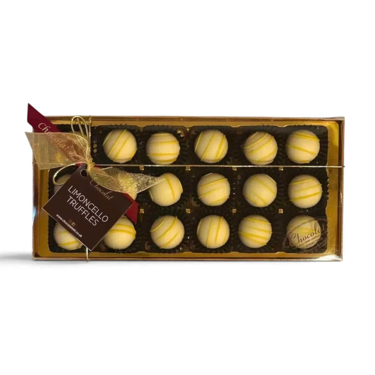 Chocolat in Kirkby Lonsdale gift box of 18 white chocolate truffles with yellow drizzle, tied with a gold ribbon.