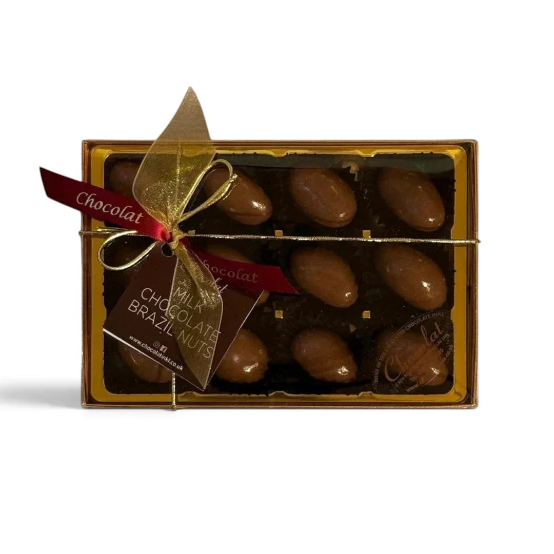 Chocolat in Kirkby Lonsdale gift box containing 12 milk chocolate covered Brazil nuts with a decorative gold ribbon.