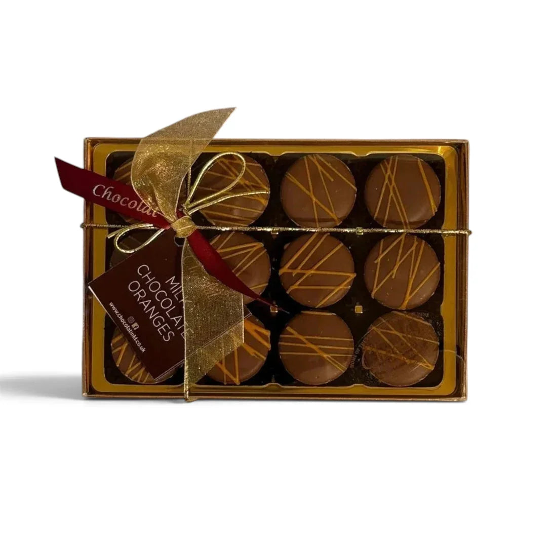 Chocolat in Kirkby Lonsdale gift box of 12 milk chocolate oranges with orange drizzle and a decorative gold ribbon.