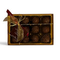Chocolat in Kirkby Lonsdale gift box of 12 salted caramel milk chocolate truffles with a gold ribbon and tag.