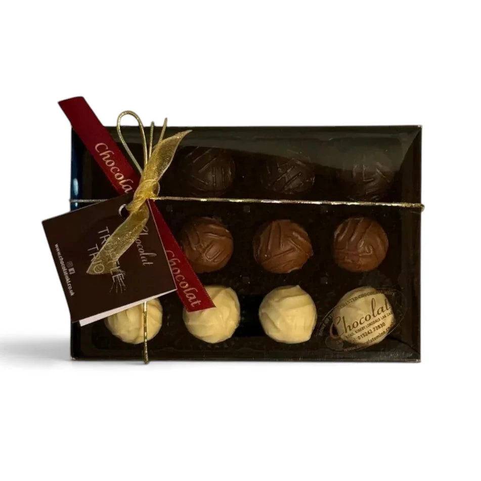 Chocolat in Kirkby Lonsdale gift box of 12 assorted milk, white, and dark chocolate truffles with a gold ribbon.