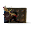 Chocolat in Kirkby Lonsdale gift box of 12 dark chocolate violet fondant creams with gold ribbon and branded tag