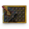 Chocolat in Kirkby Lonsdale gift box of 24 dark chocolate violet fondant creams with gold ribbon and floral topping